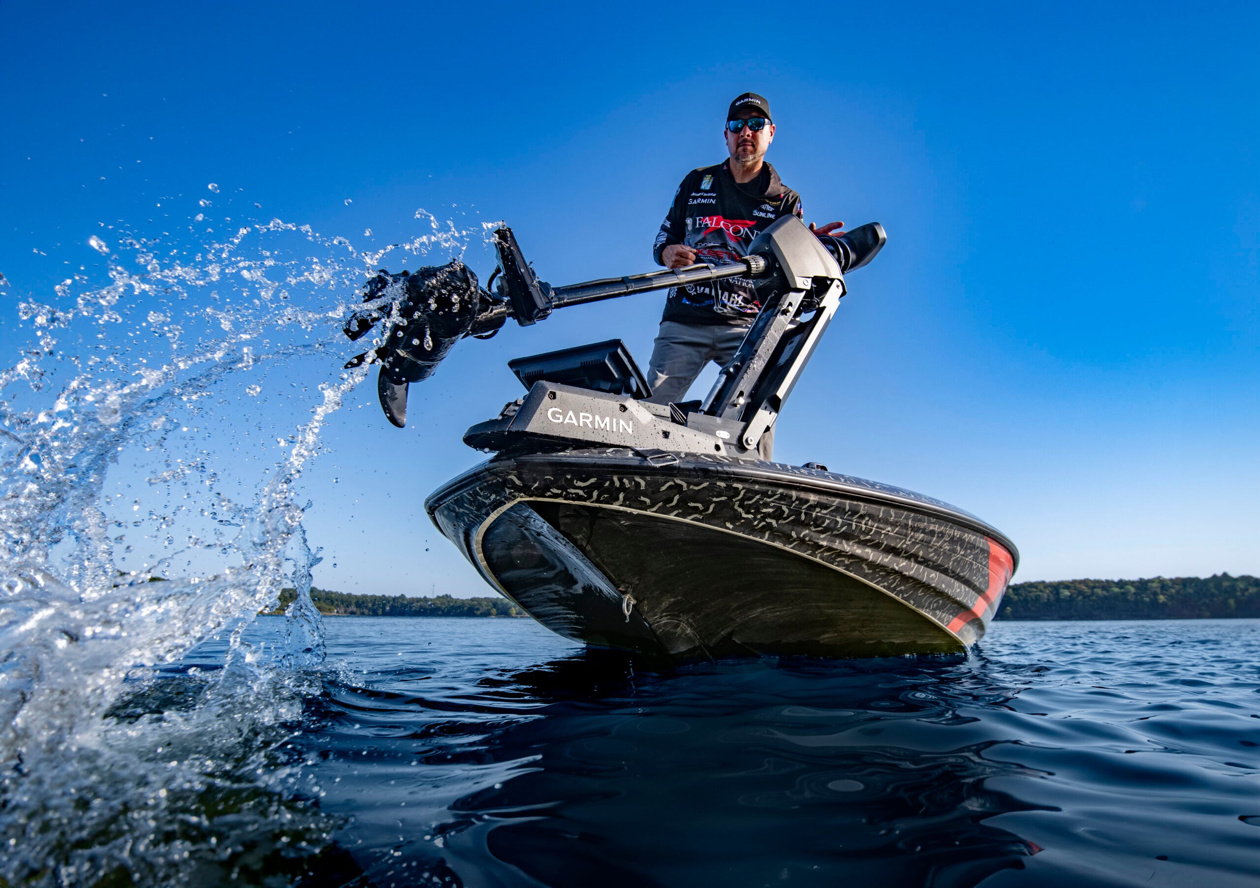 Close-up of trolling motor coming out of the water and making a splash.
