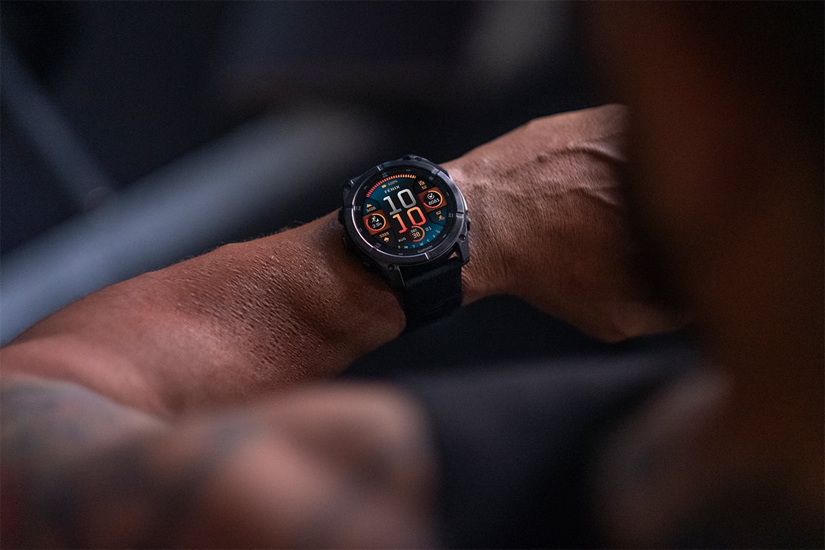 A fēnix 8 GPS smartwatch on a man's wrist displays the time of 10:10.