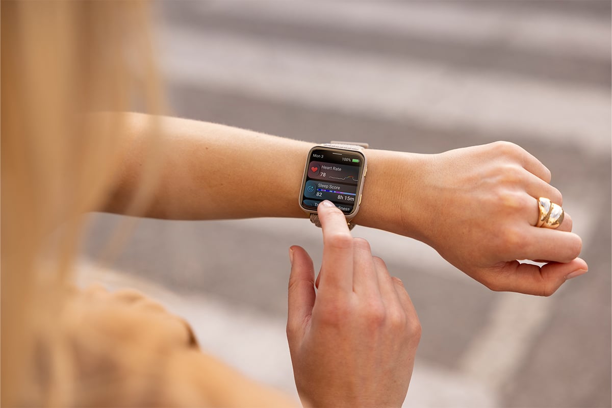 A man wearing a Garmin smartwatch checks his resting heart rate.